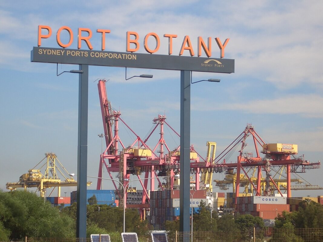 Container cranes behind the Port Botany sign in Sydney, Australia
